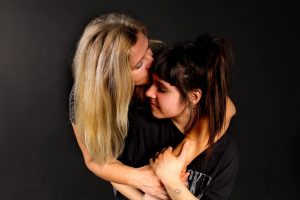 woman kissing girl on forehead